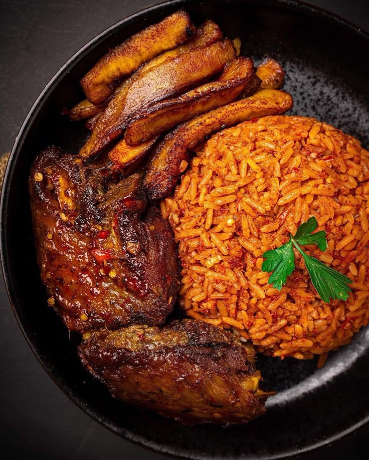 A plate of jollof rice, fried plantain and grilled meat