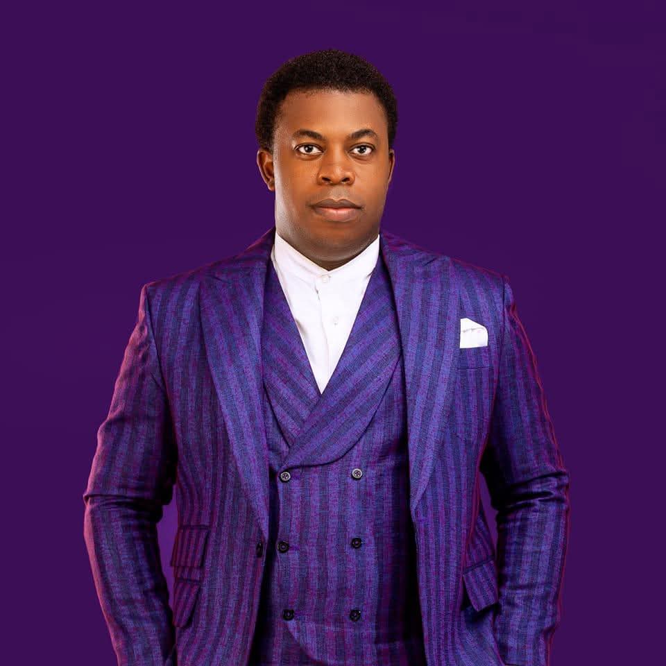 Kingnewman, founder of Enjoy Badagry, dressed in a purple suit
